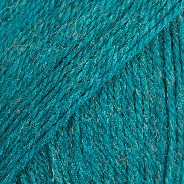 Close-up image of a soft yarn skein made from 65% wool and 35% alpaca wool, showcasing its smooth, luxurious texture. The yarn is a light, airy fiber perfect for knitting and crochet projects, with a rich sheen highlighting the natural beauty of alpaca wool. Ideal for creating warm, lightweight garments