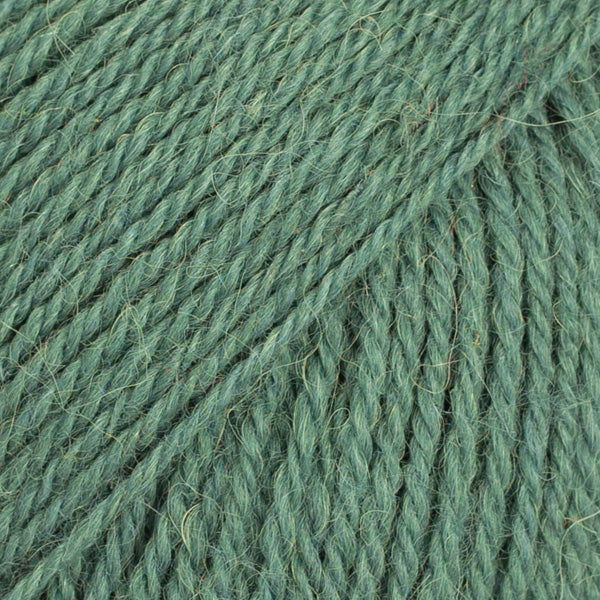 Close-up image of a soft yarn skein made from 65% wool and 35% alpaca wool, showcasing its smooth, luxurious texture. The yarn is a light, airy fiber perfect for knitting and crochet projects, with a rich sheen highlighting the natural beauty of alpaca wool. Ideal for creating warm, lightweight garments