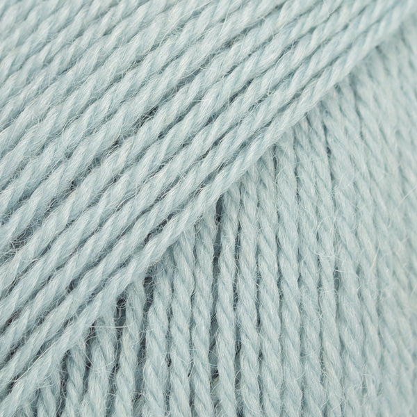 Close-up image of a soft yarn skein made from 65% wool and 35% alpaca wool, showcasing its smooth, luxurious texture. The yarn is a light, airy fiber perfect for knitting and crochet projects, with a rich sheen highlighting the natural beauty of alpaca wool. Ideal for creating warm, lightweight garments