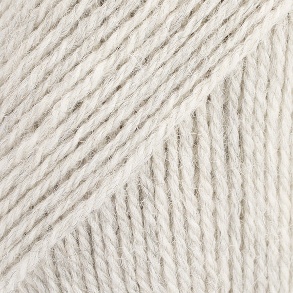 Close-up image of a soft yarn skein made from 65% wool and 35% alpaca wool, showcasing its smooth, luxurious texture. The yarn is a light, airy fiber perfect for knitting and crochet projects, with a rich sheen highlighting the natural beauty of alpaca wool. Ideal for creating warm, lightweight garments