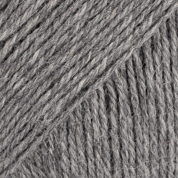 Close-up image of a soft yarn skein made from 65% wool and 35% alpaca wool, showcasing its smooth, luxurious texture. The yarn is a light, airy fiber perfect for knitting and crochet projects, with a rich sheen highlighting the natural beauty of alpaca wool. Ideal for creating warm, lightweight garments