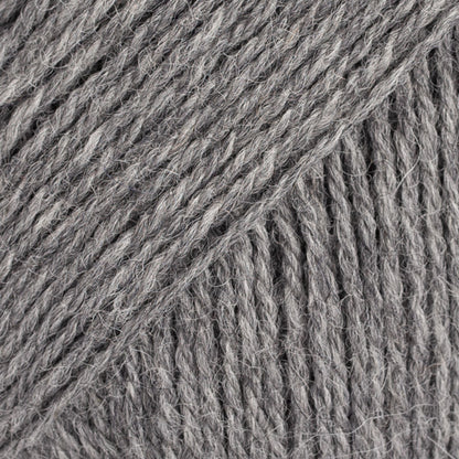 Close-up image of a soft yarn skein made from 65% wool and 35% alpaca wool, showcasing its smooth, luxurious texture. The yarn is a light, airy fiber perfect for knitting and crochet projects, with a rich sheen highlighting the natural beauty of alpaca wool. Ideal for creating warm, lightweight garments