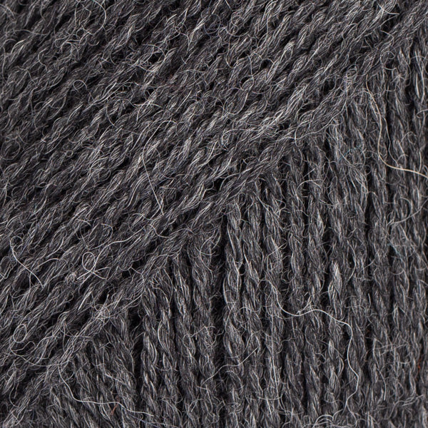 Close-up image of a soft yarn skein made from 65% wool and 35% alpaca wool, showcasing its smooth, luxurious texture. The yarn is a light, airy fiber perfect for knitting and crochet projects, with a rich sheen highlighting the natural beauty of alpaca wool. Ideal for creating warm, lightweight garments