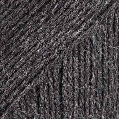 Close-up image of a soft yarn skein made from 65% wool and 35% alpaca wool, showcasing its smooth, luxurious texture. The yarn is a light, airy fiber perfect for knitting and crochet projects, with a rich sheen highlighting the natural beauty of alpaca wool. Ideal for creating warm, lightweight garments