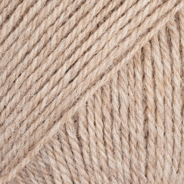 Close-up image of a soft yarn skein made from 65% wool and 35% alpaca wool, showcasing its smooth, luxurious texture. The yarn is a light, airy fiber perfect for knitting and crochet projects, with a rich sheen highlighting the natural beauty of alpaca wool. Ideal for creating warm, lightweight garments