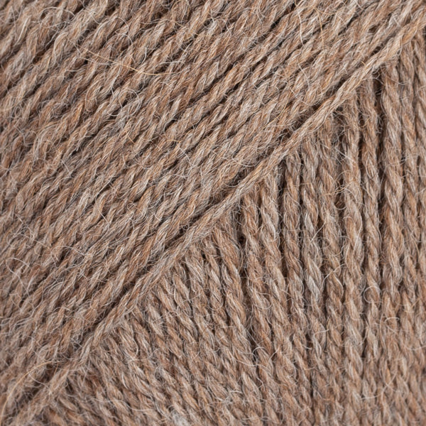 Close-up image of a soft yarn skein made from 65% wool and 35% alpaca wool, showcasing its smooth, luxurious texture. The yarn is a light, airy fiber perfect for knitting and crochet projects, with a rich sheen highlighting the natural beauty of alpaca wool. Ideal for creating warm, lightweight garments