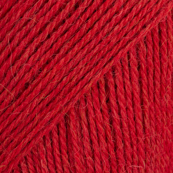 Close-up image of a soft yarn skein made from 65% wool and 35% alpaca wool, showcasing its smooth, luxurious texture. The yarn is a light, airy fiber perfect for knitting and crochet projects, with a rich sheen highlighting the natural beauty of alpaca wool. Ideal for creating warm, lightweight garments