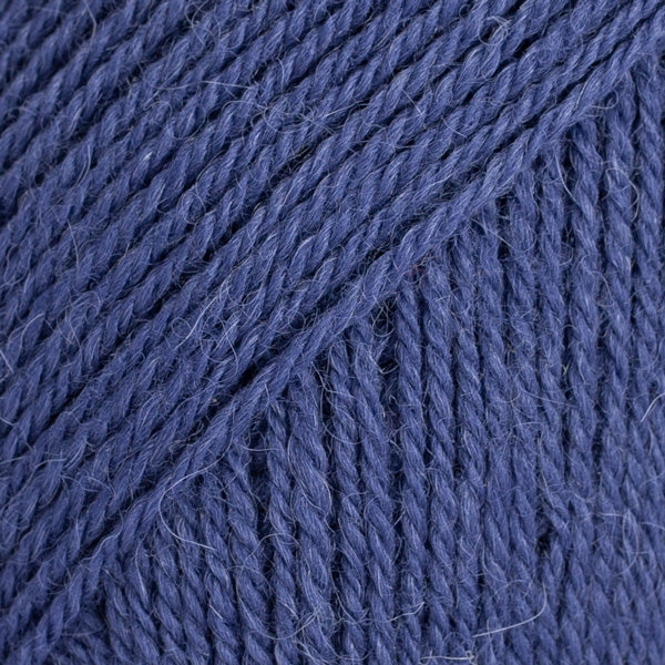 Close-up image of a soft yarn skein made from 65% wool and 35% alpaca wool, showcasing its smooth, luxurious texture. The yarn is a light, airy fiber perfect for knitting and crochet projects, with a rich sheen highlighting the natural beauty of alpaca wool. Ideal for creating warm, lightweight garments