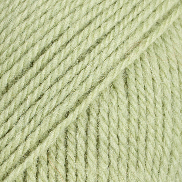 Close-up image of a soft yarn skein made from 65% wool and 35% alpaca wool, showcasing its smooth, luxurious texture. The yarn is a light, airy fiber perfect for knitting and crochet projects, with a rich sheen highlighting the natural beauty of alpaca wool. Ideal for creating warm, lightweight garments