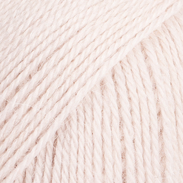 Close-up image of a soft yarn skein made from 65% wool and 35% alpaca wool, showcasing its smooth, luxurious texture. The yarn is a light, airy fiber perfect for knitting and crochet projects, with a rich sheen highlighting the natural beauty of alpaca wool. Ideal for creating warm, lightweight garments