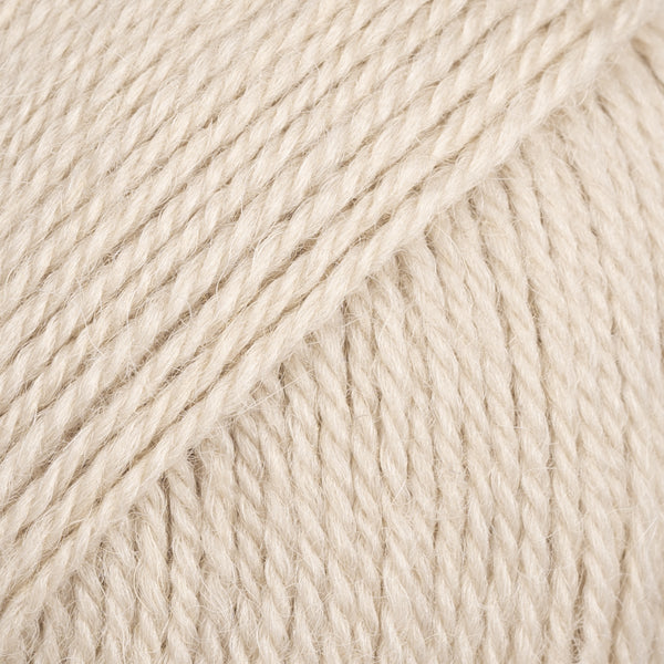 Close-up image of a soft yarn skein made from 65% wool and 35% alpaca wool, showcasing its smooth, luxurious texture. The yarn is a light, airy fiber perfect for knitting and crochet projects, with a rich sheen highlighting the natural beauty of alpaca wool. Ideal for creating warm, lightweight garments